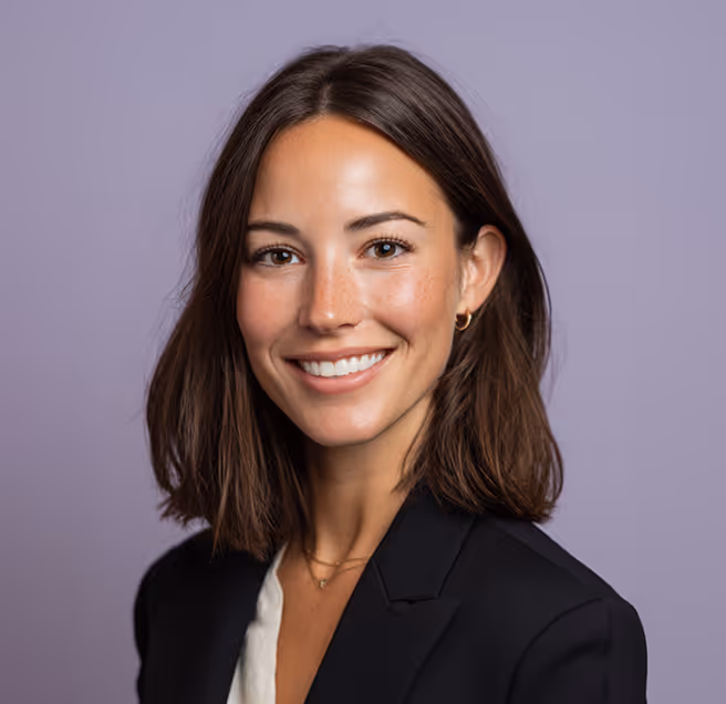 A formally dressed woman smiling confidently, conveying professionalism and trust in recruitment services.